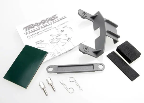 Battery Hold-Down (Grey) (1) / Receiver Hold-Down (Grey) (1) / Metal Posts (2)/ Spacers (2)/ Body Clips (2)/ Servo Tape/ Adhesive Foam Pad 1